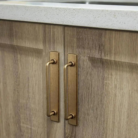 Two Pack 5 Inch Center To Center Antique Brass Cabinet Bar Pulls With Backplates installed on wooden cabinet doors