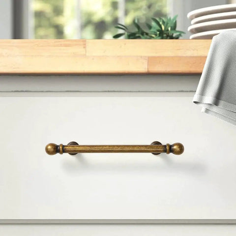 Antique Brass Drawer Pull on white dresser, solid zinc, aged bronze finish, 3-3/4 inch center, part of set of 10 handles