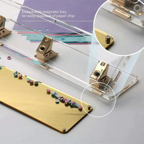 Close-up of clear acrylic 3 hole punch for 10 sheets with gold accents, showing magnetic detachable base and anti-slip pad.