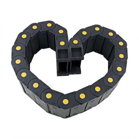 Heart-shaped arrangement of R55 25mm By 77mm Plastic Cable Drag Chain Wire Carrier With Openable Cover Closed Type resting on white surface.