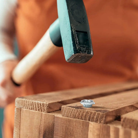 Person hammering Three Eighths Inch T Nuts Four Pronged Tee Nut Zinc Plated Steel into wood surface.