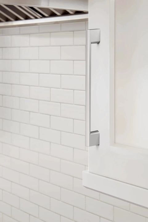 Installed Polished Chrome Cabinet Pull Cityscape Collection 7-3/8 Inch on white cabinet against subway tile backsplash