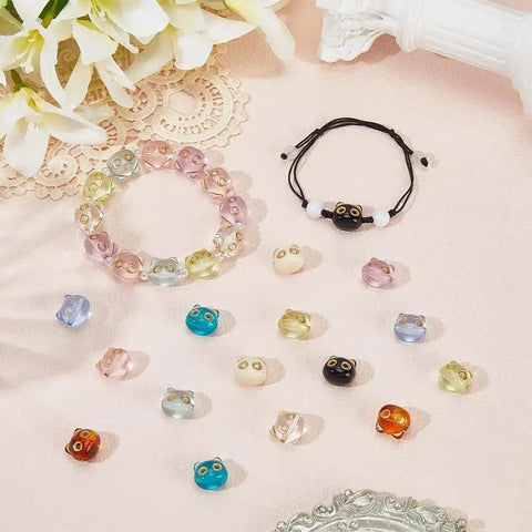 Colorful Acrylic Cat Beads Kit 100 Pcs displayed with bracelets and loose 3D cat face spacers for jewelry making and DIY crafts.