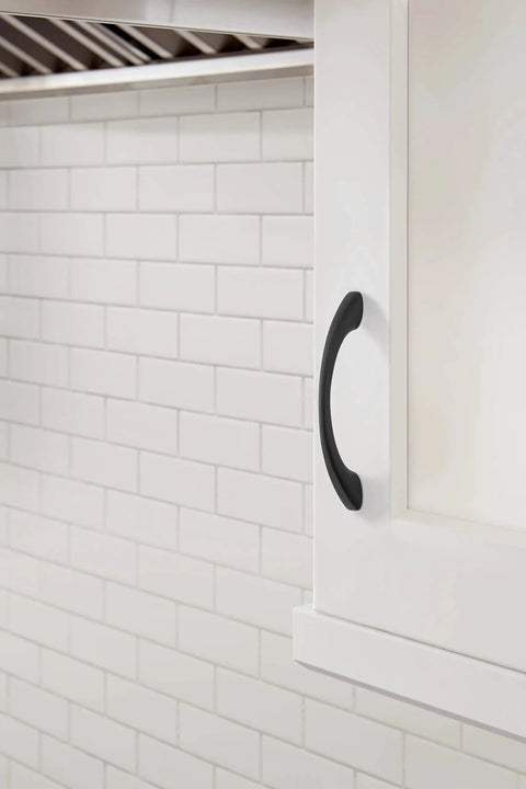 Vaile Matte Black Cabinet Pull 3-3/4 Inch Center to Center installed on a white cabinet, showcasing modern drawer handle.