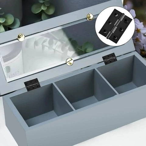 Two Inch Stainless Steel Folding Hinges For Wood Doors And Wooden Boxes Ideal For Small Crafts And Lightweight Projects Includes 108 Screws Durable Mounting Hardware For Easy Installation installed on a wooden box.