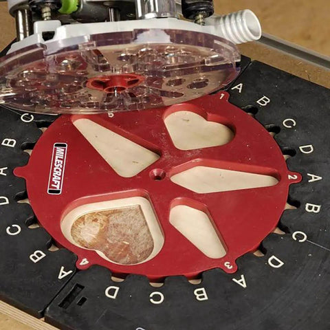 Design And Inlay Router Template Jig Kit For DIY Woodworking With 25 Pattern Ideas Pencil Guide and red template on a wood panel.