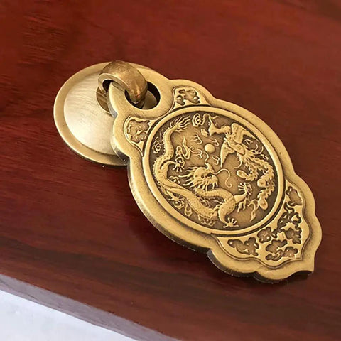 Chinese Style Vintage Brass Drawer Pulls Set Of 2 With Antique Bronze Finish on wooden surface, ornate dragon design