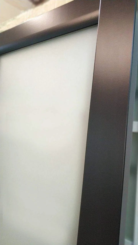 Close-up of the black matte frame and frosted glass panel of the Interior Sliding Barn Door With Frosted Glass, Solid Wood Construction, 32x84 Inches, Black Modern Style, Hardware Included Kit With Steel Rail, Hangers, Floor Guide, Door Stop And Anti Jump Pins For Smooth, Quiet Sliding.