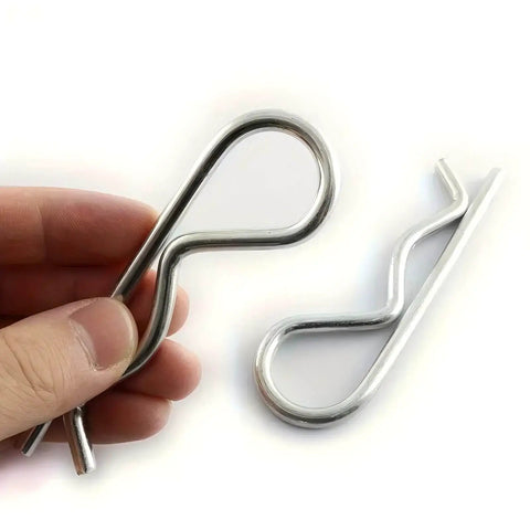 10 Pack Spring Hitch Cotter Hair Pins And White Zinc Plated Retaining Wire Clips For Trailers And Equipment, shown in hand and on surface