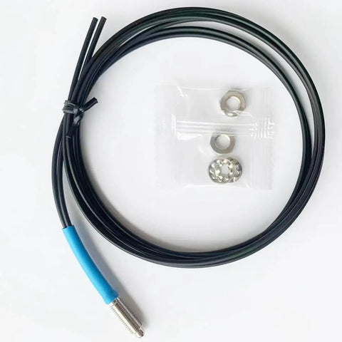FU610 Fiber Optic Sensor with 1 meter black cable and M6 probe, for diffuse reflective digital sensing, shown with nuts and washers