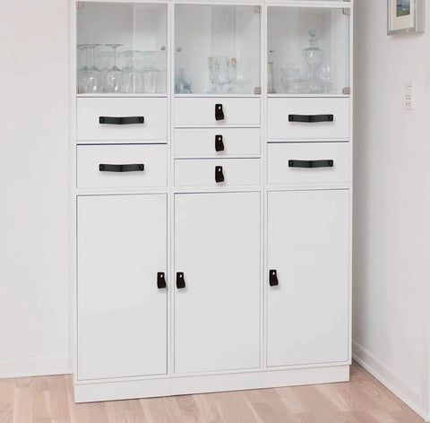 White cabinet with Black Leather Drawer Pulls 2 Piece Set Measuring 7 7/8 By 1 1/2 Inches Leather Handles installed on drawers.