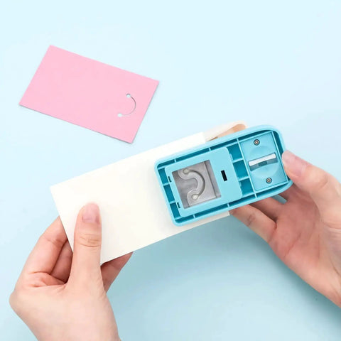 Person using Versatile Hangtag Punch For DIY Jewelry Displays And Card Tags, Corner Punch Tool For Keychains, on light paper