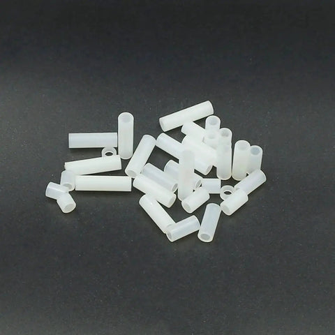 Nylon Round Unthreaded Spacers Kit For M3 Screws, 300 Pc White Assortment scattered, showing 5mm OD and 3.2mm ID, various lengths.