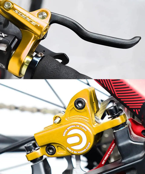 Front view of Meteorolite gold MTB hydraulic disc brake lever on aluminum handlebar; caliper installed with PM adapter.