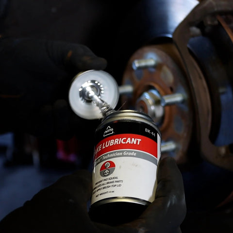 SIL-Glyde silicone brake grease, 4 oz brush-top, Amazon brand, applied to a brake caliper