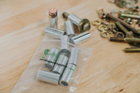 Aluminum Spacer Half OD Quarter Inch ID Standoff Fits Quarter Inch Or M6 Bolts in packaging with bolts and washers nearby