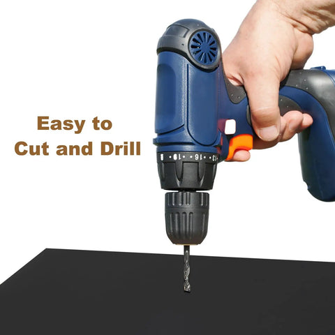 Hand holding a drill over a black Hard UHMW Polyethylene Sheet For Heavy Duty Use By Meccanixity, 10 X 12 X 0.1 In.