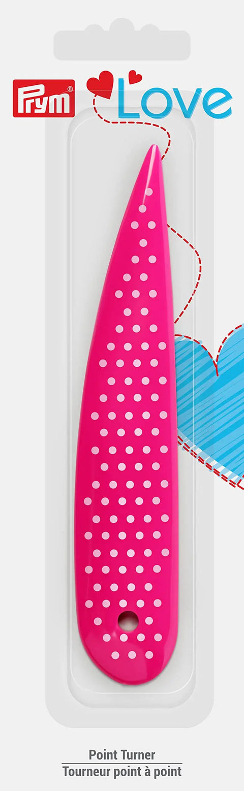 Pink Point Turner For Sewing And Quilting By Prym Love with blunt point and curved end in retail packaging, dotted design visible.