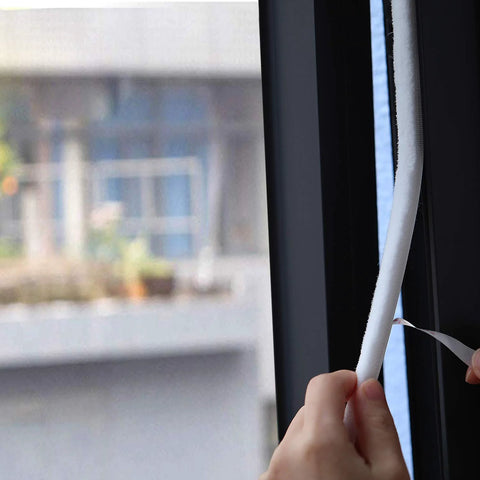 TORRAMI fuzzy brush weatherstripping for window and door, white, self-adhesive felt seal, being applied to window frame