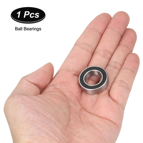Ball bearing 15x26x7 mm with silver metal housing and black seal held in hand