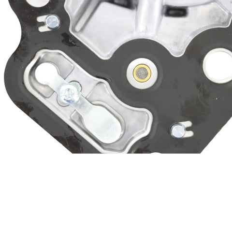 Brake vacuum pump mounting plate on black base with silver fittings and circular mesh seal