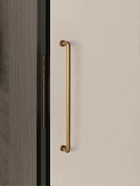 10 Inch Cabinet Bar Pulls With Antique Brass Finish 256mm Hole Centers Set Of 2 for cabinets, shown on a beige cupboard door.