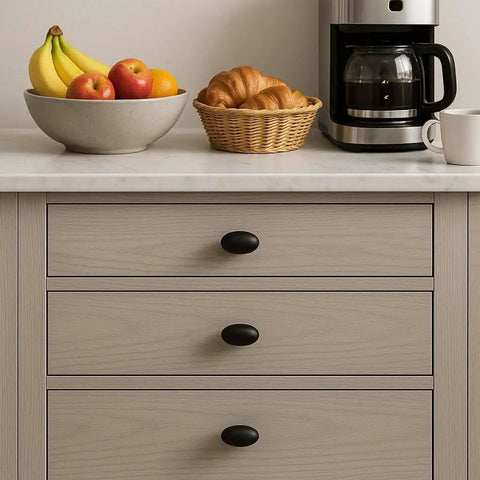 Oval Matte Black Cabinet Knobs 10 Pack For Kitchen And Furniture By EAXINTA installed on wooden drawers with kitchen items