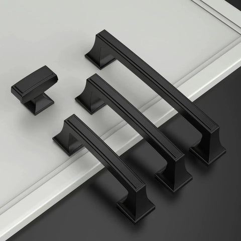 Set of matte black cabinet handles and single knob on a light background, featuring the 10 Pack 1.4 Inch 35mm Matte Black Cabinet Knobs for Kitchen Cabinets and Dressers, Zinc Alloy Drawer Hardware for Dresser Drawers and Furniture Renovation.