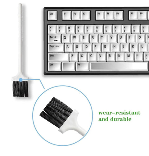 Keyboard cleaning brush next to a mechanical keyboard, highlighting its wear-resistant bristles and durable handle.
