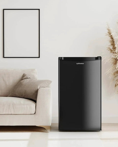 Black 3.2 Cu Ft Single Door Mini Fridge With Freezer for dorm, office, bedroom next to sofa in living room setting