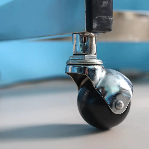 Close-up of 1.56 Inch Ball Caster Wheels Set Of 4 With Threaded Stem 360 Degree Movable Rotatable Castors in black finish, attached to furniture leg.