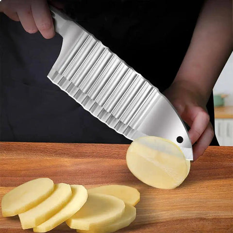 Crinkle Cut Knife For Potatoes And Vegetables With Wavy Ridged Blade slicing potatoes on a wooden board