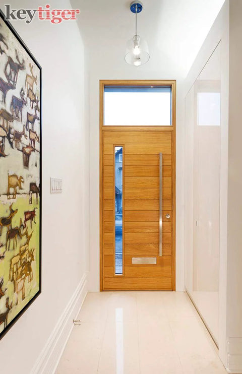 Wooden front door with 60 Inch Long Modern Matte Black Stainless Steel Door Handles And Front Door Pulls installed in a hallway.