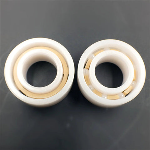 Two white R188 full-ceramic ball bearings, 1/4 in bore x 1/2 in OD x 3/16 in width, with beige inner retainers.