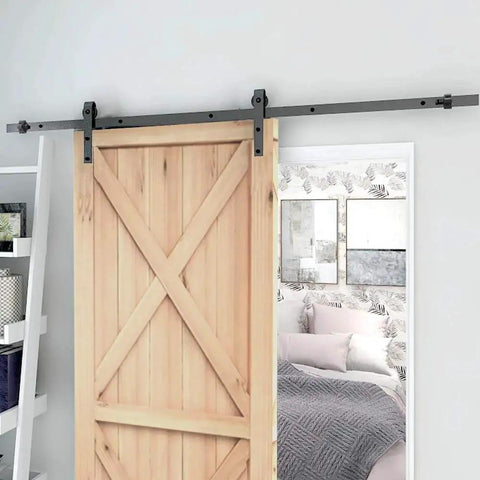 Sliding Barn Door Stopper Rail Stop For Single Or Double Doors, Top Flat Track And Center Or End Install, Adjustable Fit For 1.57 Inch Width Tracks 40mm, Black Satin Aluminum Alloy Construction, Corrosion Resistant, 1 Pair, installed on a wooden sliding door.