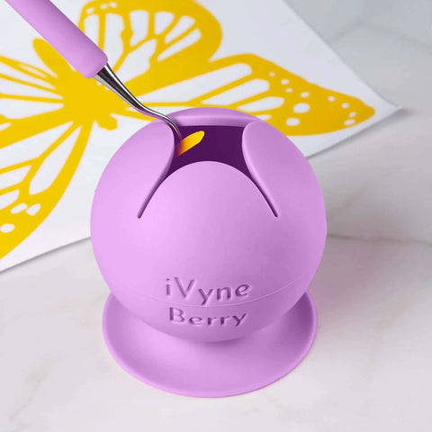 Berry Suctioned Vinyl Weeding Scrap Collector And Holder For Vinyl Weeding Tools With Star Shaped Opening Keeps Scrap Vinyl In Place And Makes Cleanup Easy For Crafters Purple By iVyne in use holding vinyl scrap with butterfly design in background.