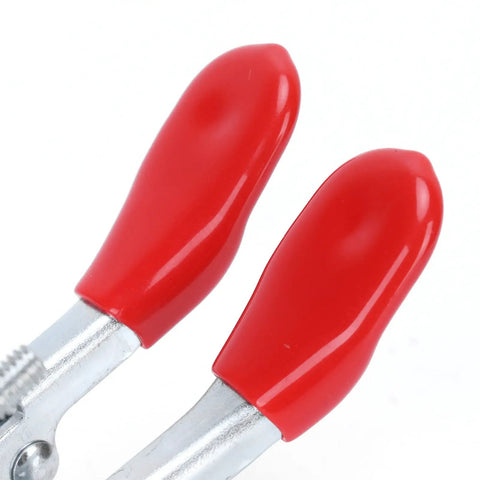 Close-up of red handles on a Rock Solid Ergonomic Toggle Clamp Set With Six Point One Lb Holding Power For Secure Woodworking.