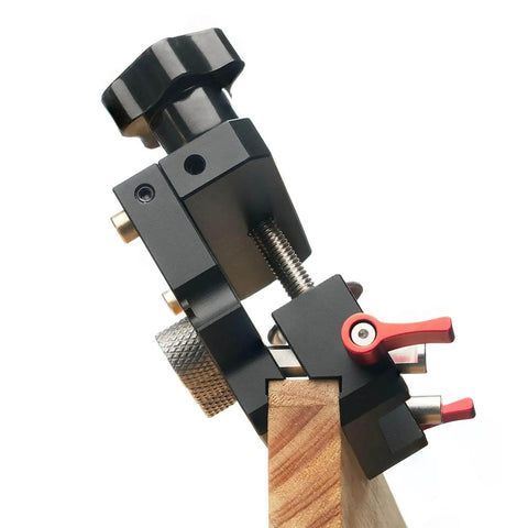 Pro Grade Self Centering Doweling Jig Kit With Anodized Finish For Easy Accurate Woodworking And Furniture Assembly Includes Precise Alignment Etched Guides Three Drill Bits Sleeves And Limiters For Quick Clean Joints, side view of doweling jig clamped to wood, close-up.