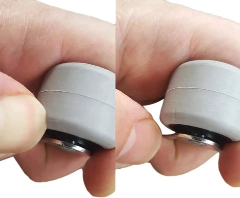 Close-up of hand holding small rubber wheel from Pack Of 8 Small 1.18 Inch Rubber Wheel Casters For Furniture Non Swivel Non Plastic.