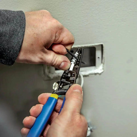Person using Heavy Duty Wire Cutter And Stripper For 10-18 AWG Solid And 12-20 AWG Stranded Wire With Precision Ground Stripping Holes