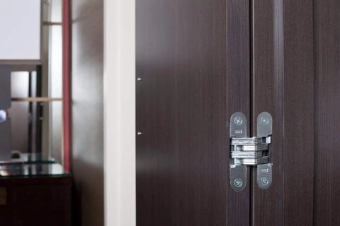 Hidden Zinc Invisible Door Hinge for wood or metal frames, mortise mount, satin nickel finish, installed on dark wood door.