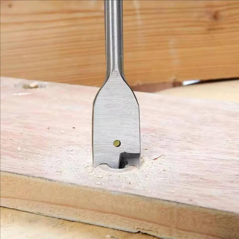 Close-up of a spade bit drilling into wood from the Six Piece Spade Drill Bit Set With Quick Change Hex Shank For Woodworking.