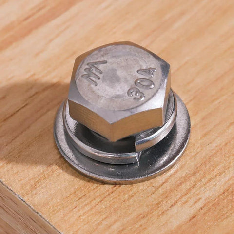 M8 stainless steel flat washer and lock washer under hex bolt on wooden surface