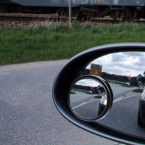 2 Pack Blind Spot Mirrors With 360 Degree Rotation, Round HD Glass, Stick On Convex Side View For Universal Cars, Black, Adjustable, Waterproof, 50mm Diameter, 12mm Thick, installed in side mirror showing road view.