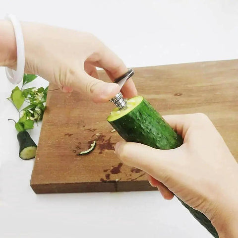 Person using 2 In 1 Veggie Spiral And Crinkle Cutter Peeler For Veggies And Potatoes Stainless Steel Spiralizer For Zucchini Carrots Potatoes And Salad Garnishes 2 Pack GYHZ on cucumber.