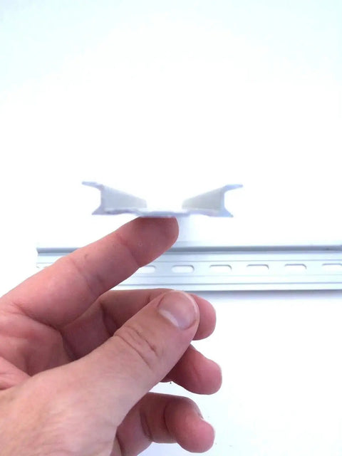 Person holding 20 Pieces 4 Inch DIN Rail Slotted Aluminum RoHS Compliant Built Tough Modular Rail For Mounting Large Components 35mm Wide 7.5mm High