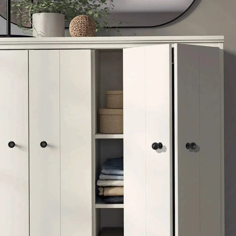 Matte Black Cabinet Knobs Four Pack With Wide Backplates shown on white bi-fold closet doors in modern interior