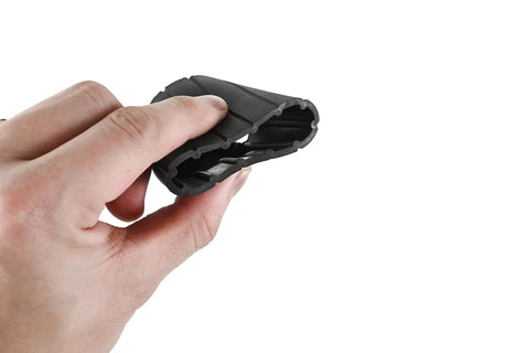 Person holding black rubber automotive component, possibly a seal or gasket, demonstrating flexibility and texture in hand.