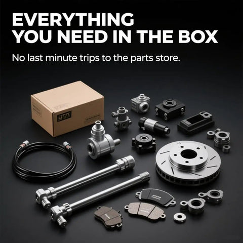 Automotive part kit with brake disc, bolts, cables, and components on a black surface, labeled 'Everything You Need in the Box'