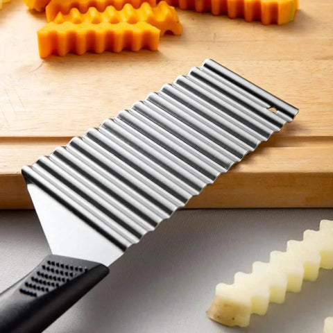 Wave Potato Cutter Crinkle Slicer For French Fries And Veggies Stainless Steel Kitchen Utensils with ergonomic handle on table.